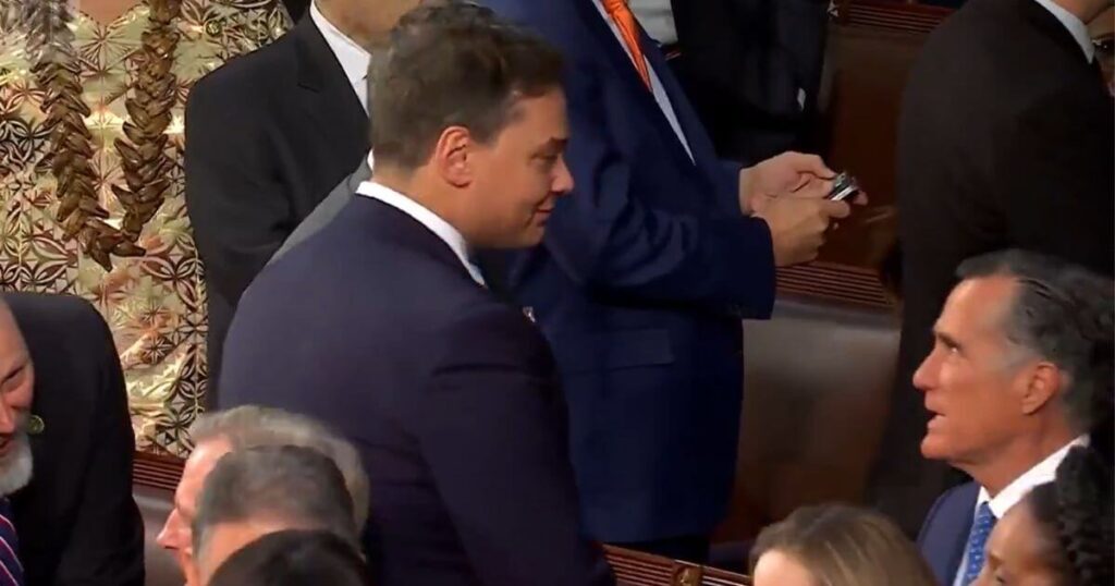 Utah Sen. Mitt Romney, right, was caught on camera in an elevated discussion with New York Rep. George Santos, left, ahead of Tuesday's State of the Union address in Washington.